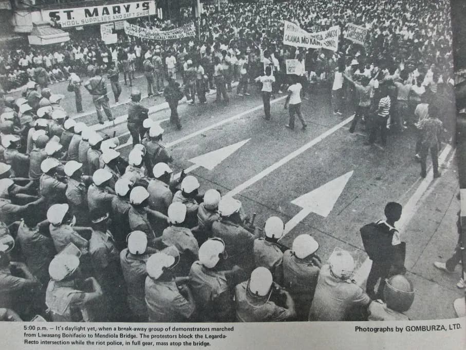Demonstrators facing rows of helmeted riot police at the Legarda and Recto intersection near Mendiola